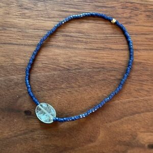 Aquamarine gemstone, gold plated bead and Japanese glass bead stretch bracelet.